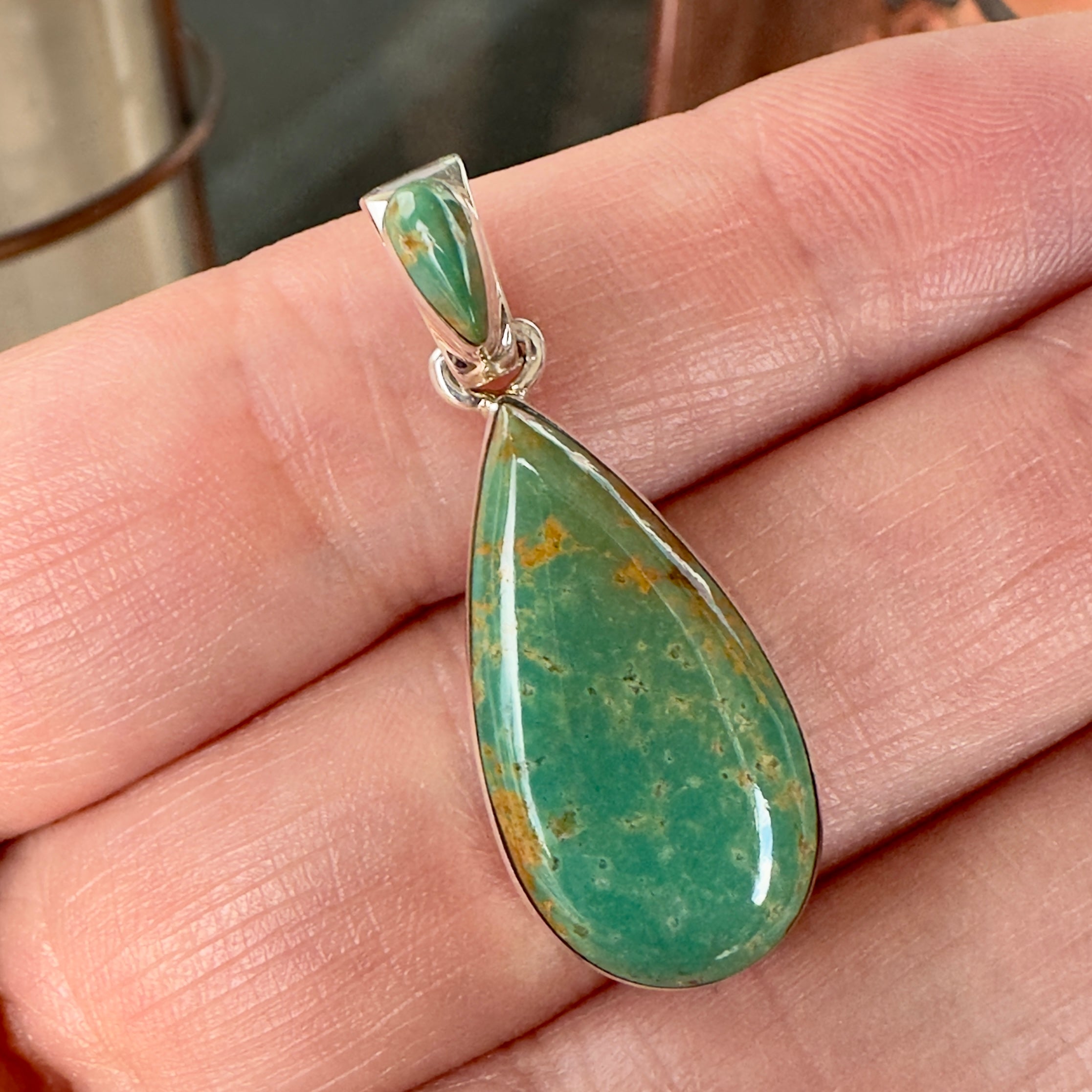 Wildflower Artisans sterling silver pendant featuring a teardrop-shaped Royston turquoise stone with golden matrix.