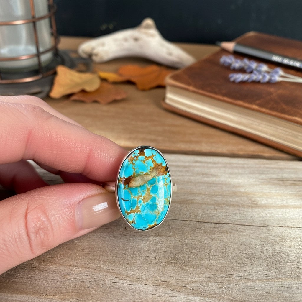 Wildflower Artisans sterling silver ring featuring an oval Royston turquoise cabochon with golden brown matrix.