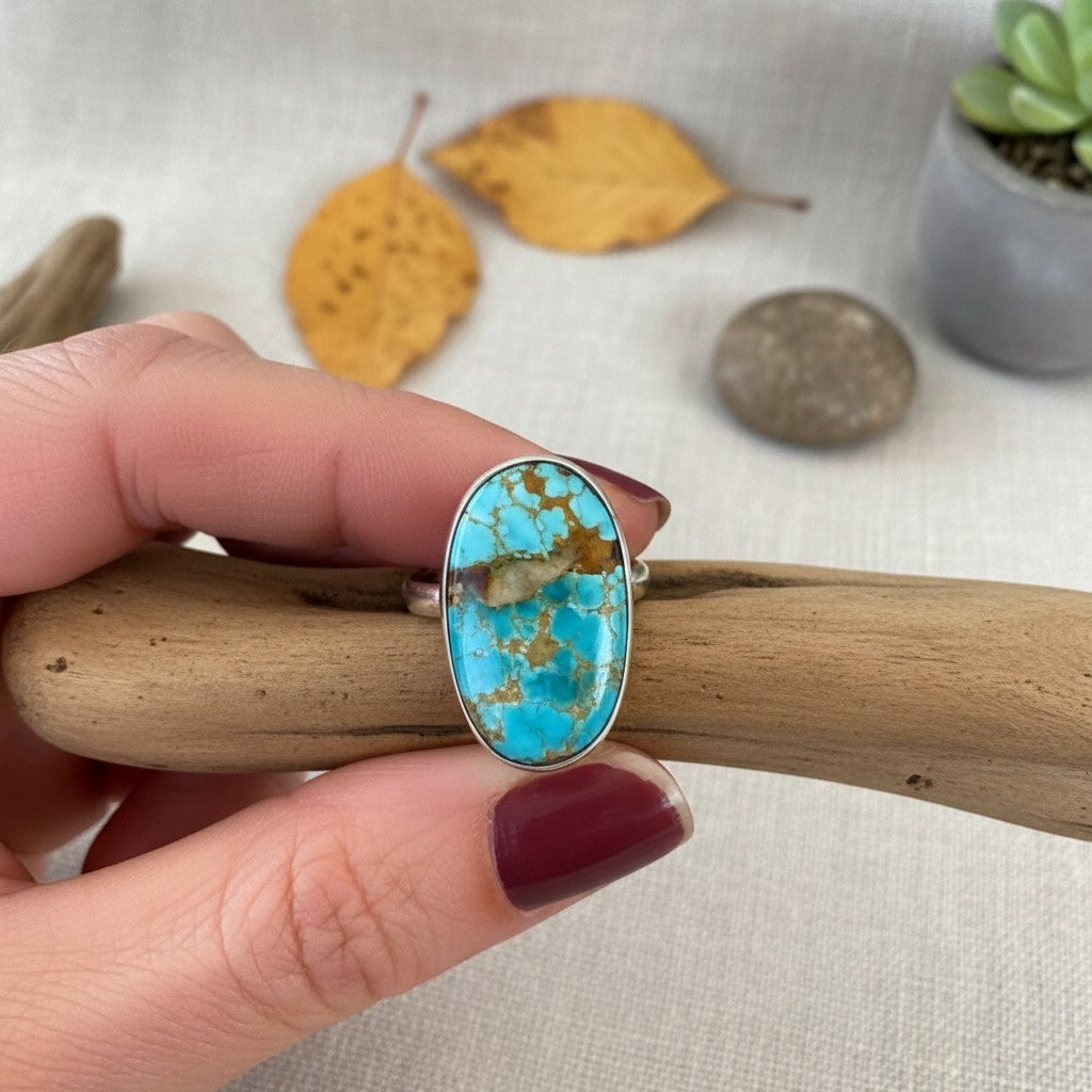 Wildflower Artisans sterling silver ring featuring an oval Royston turquoise cabochon with blue-green and brown matrix.