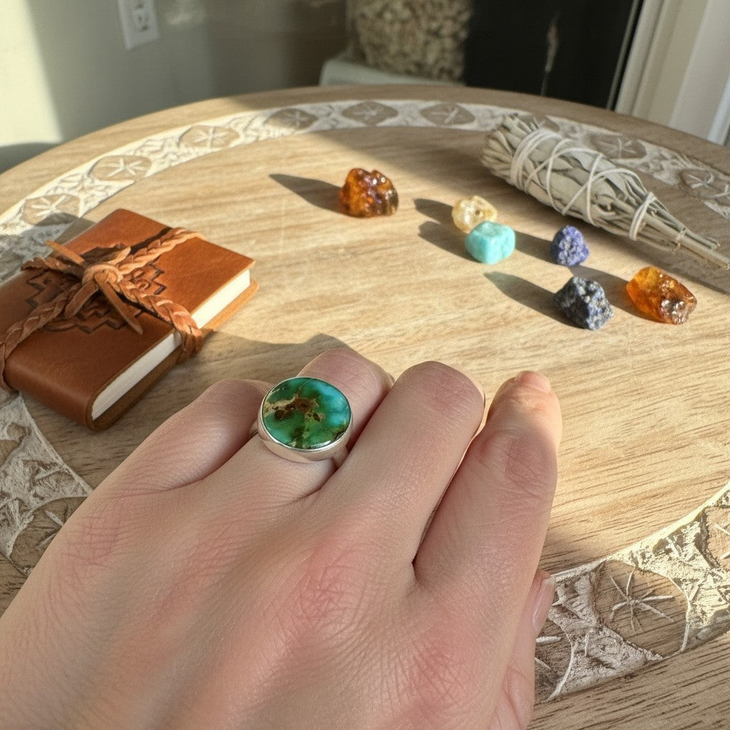 Wildflower Artisans round Sonoran Mountain turquoise ring in sterling silver bezel setting on a hand.