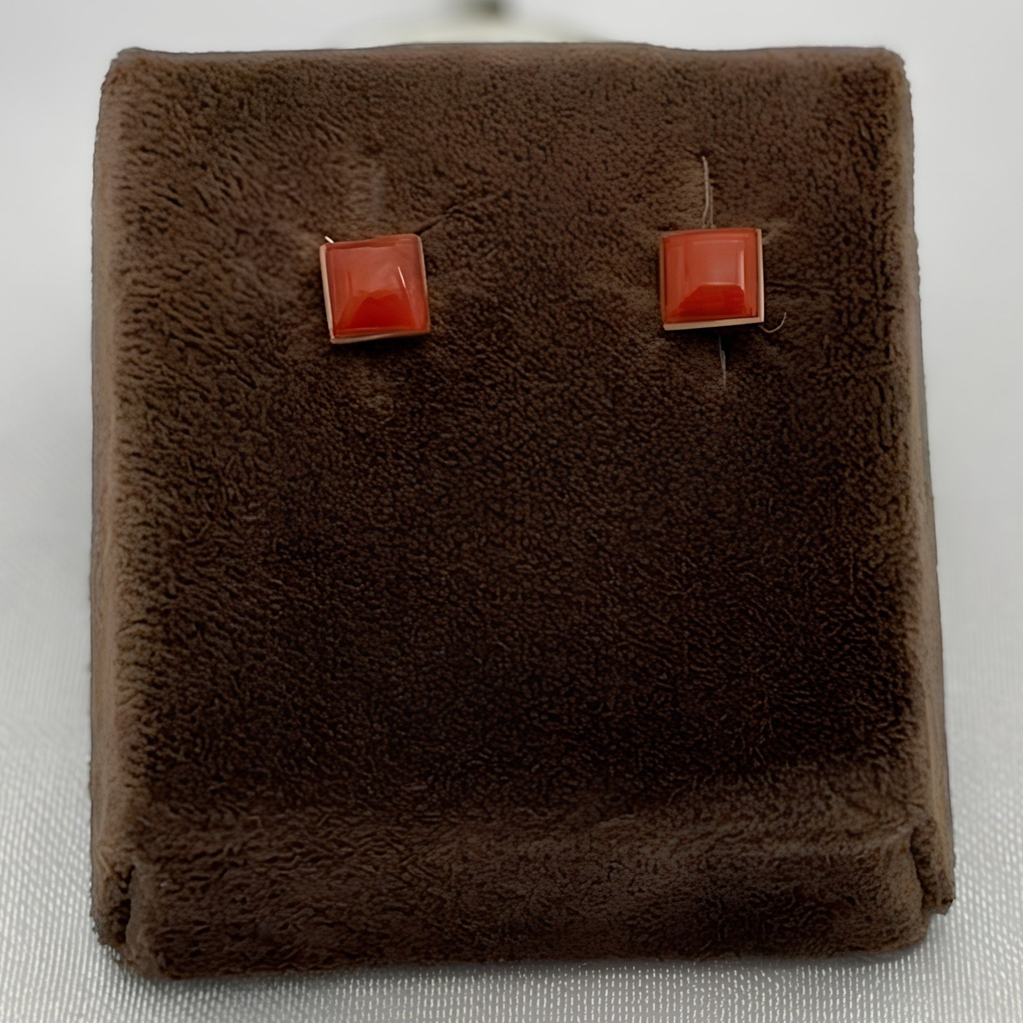 Wildflower Artisans square spiny oyster stud earrings with red-orange domed cabochons set in sterling silver.