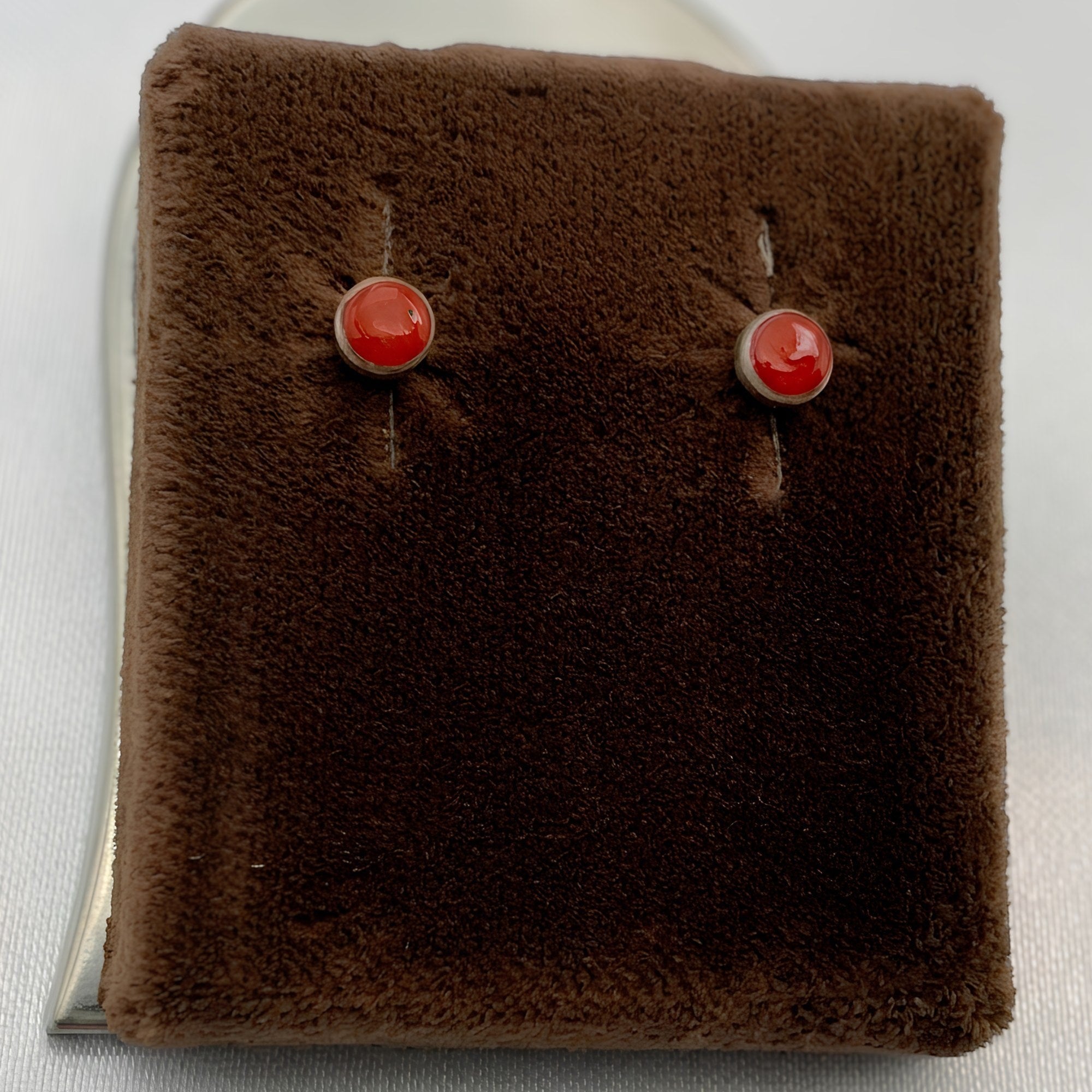 Wildflower Artisans round spiny oyster stud earrings with red-orange cabochons set in polished sterling silver.