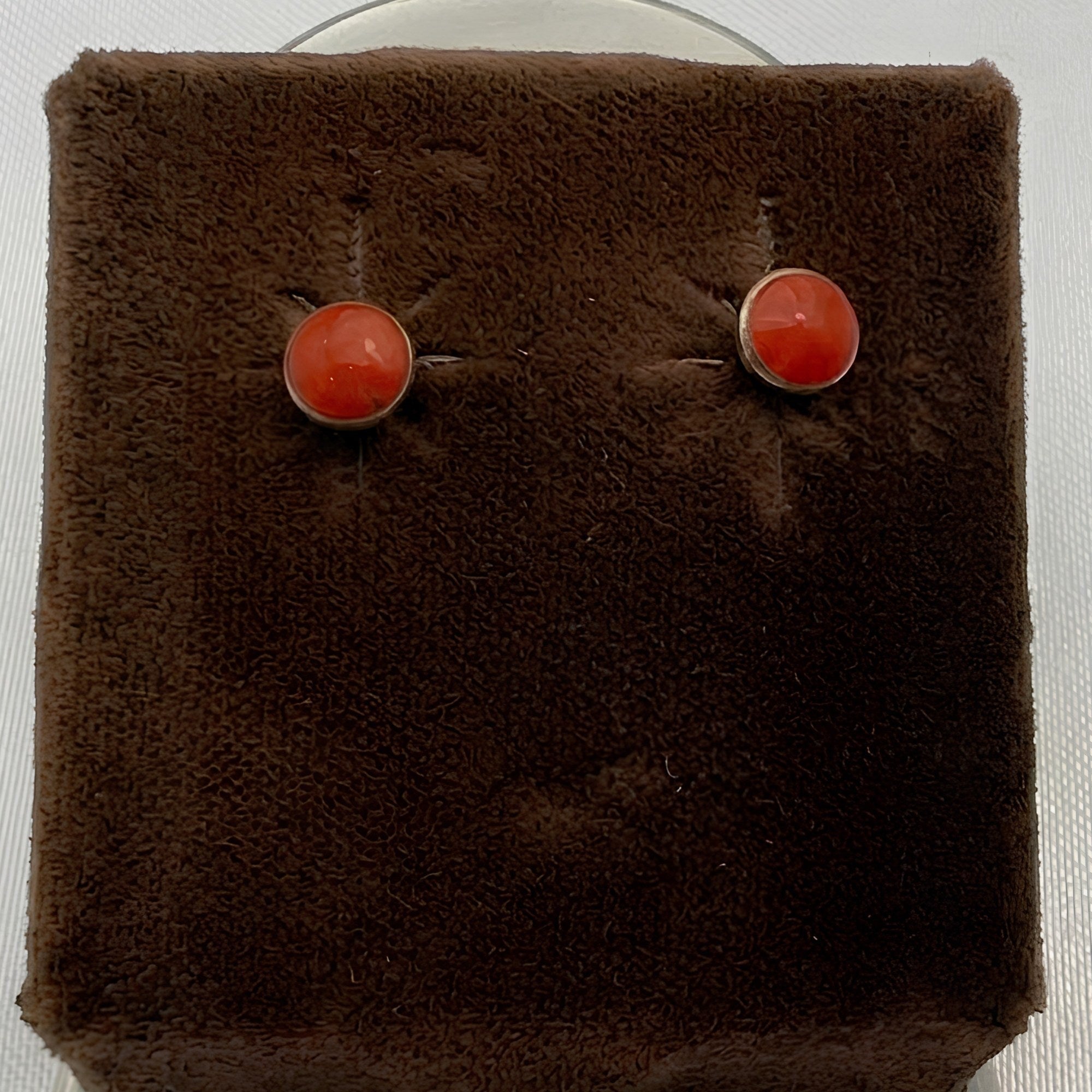 Wildflower Artisans round spiny oyster stud earrings with red-orange cabochons in sterling silver settings.