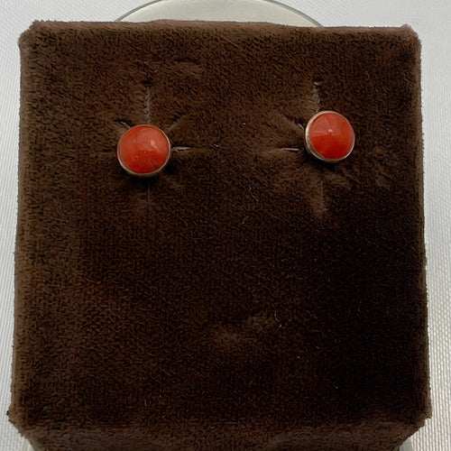 Wildflower Artisans round spiny oyster stud earrings with red-orange cabochons in sterling silver settings.