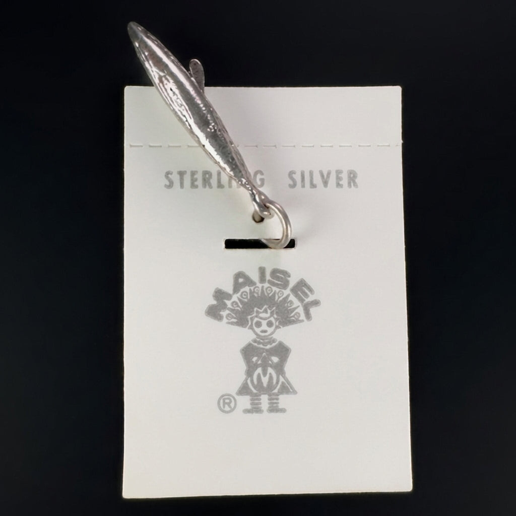 Wildflower Artisans vintage sterling silver canoe charm on original Maisel's trading post display card.