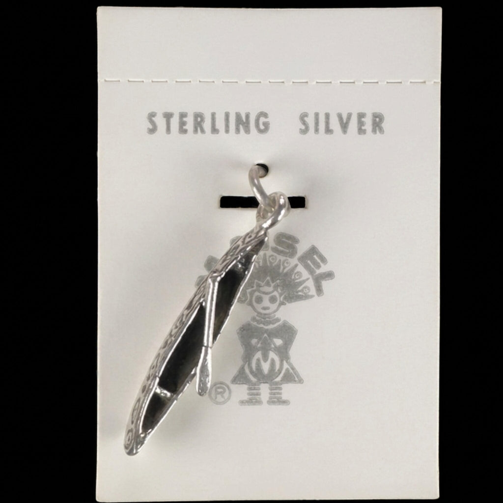 Wildflower Artisans vintage sterling silver canoe charm on original Maisel's trading post display card.
