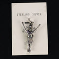 Wildflower Artisans vintage sterling silver figure charm with arms raised, attached to original Maisel's display card.