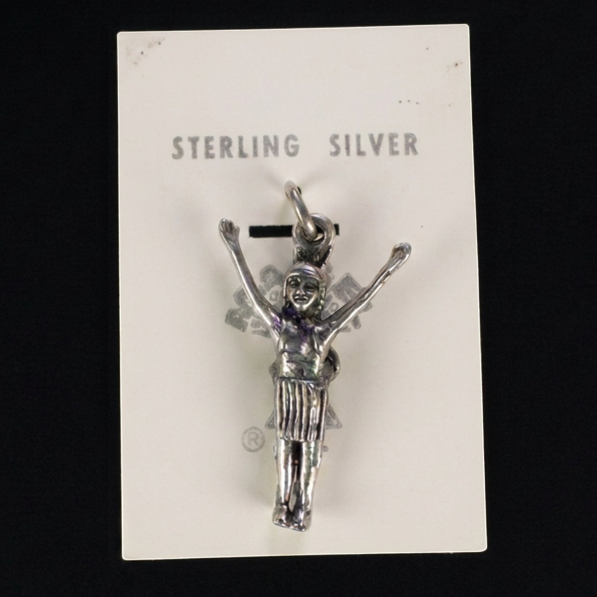 Wildflower Artisans vintage sterling silver figure charm with arms raised, attached to original Maisel's display card.