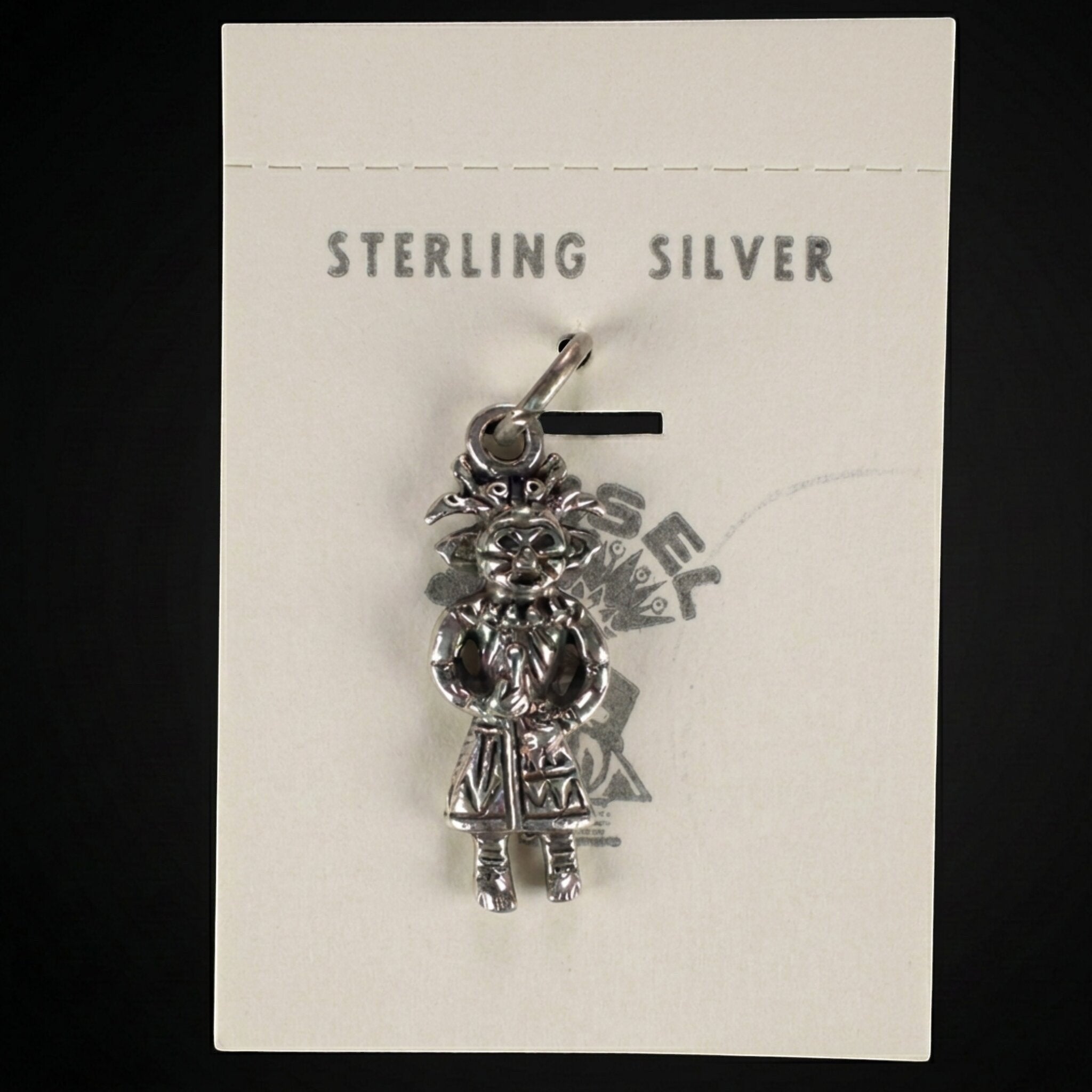 Wildflower Artisans vintage sterling silver standing figure charm on original Maisel's trading post display card