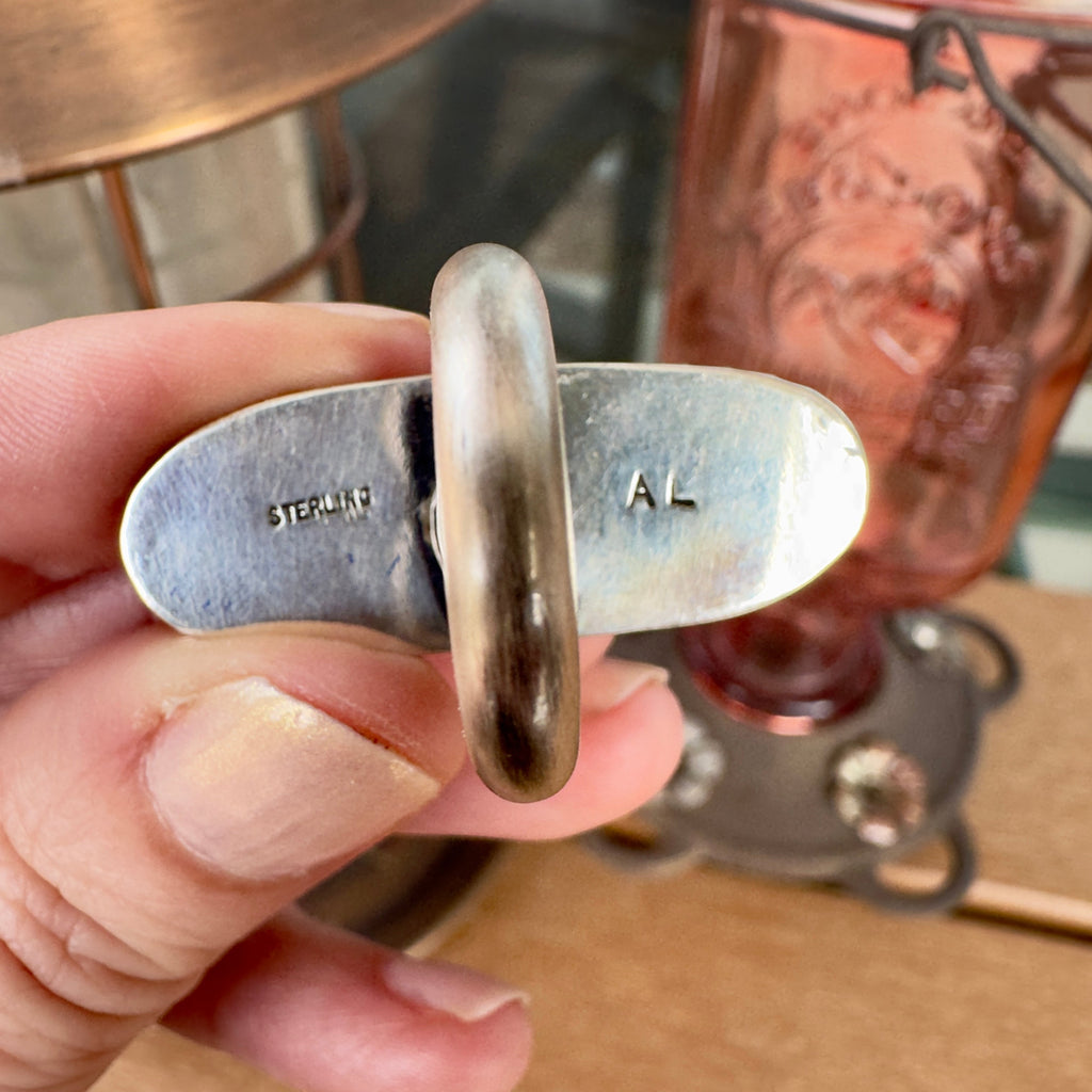 Wildflower Artisans sterling silver ring back showing AL and sterling hallmarks on the shank interior