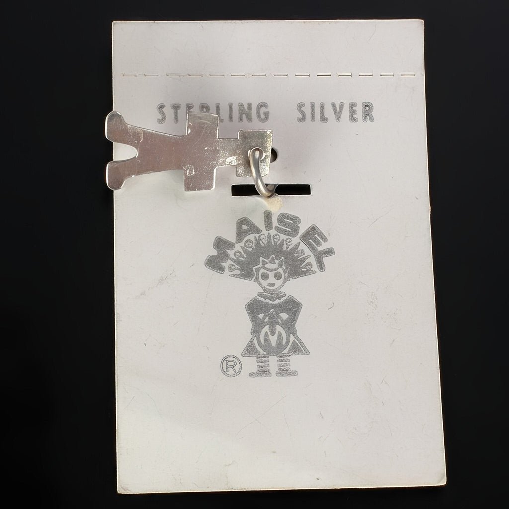 Wildflower Artisans vintage sterling silver Maisel's figure charm with a turquoise cabochon on original display card.