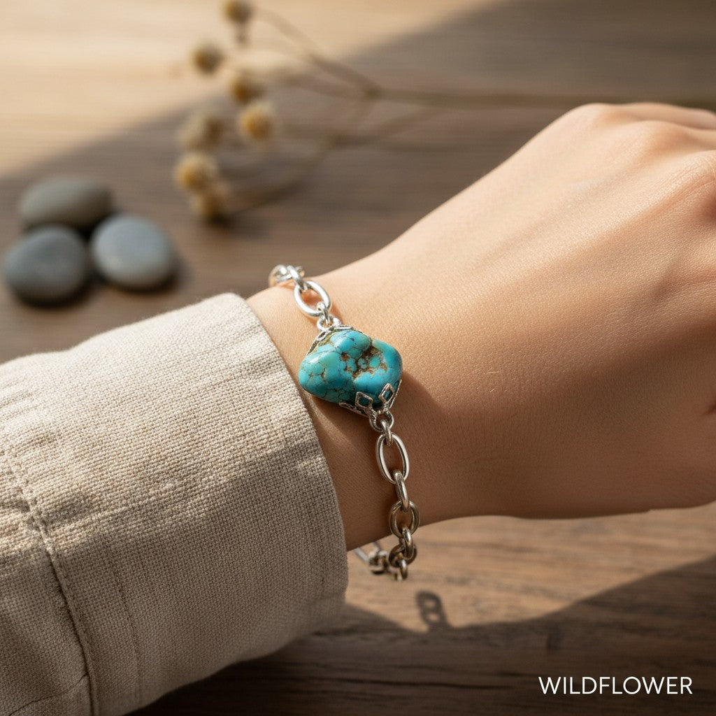 Wildflower Artisans sterling silver bracelet featuring a natural blue turquoise nugget with spiderweb matrix on wrist