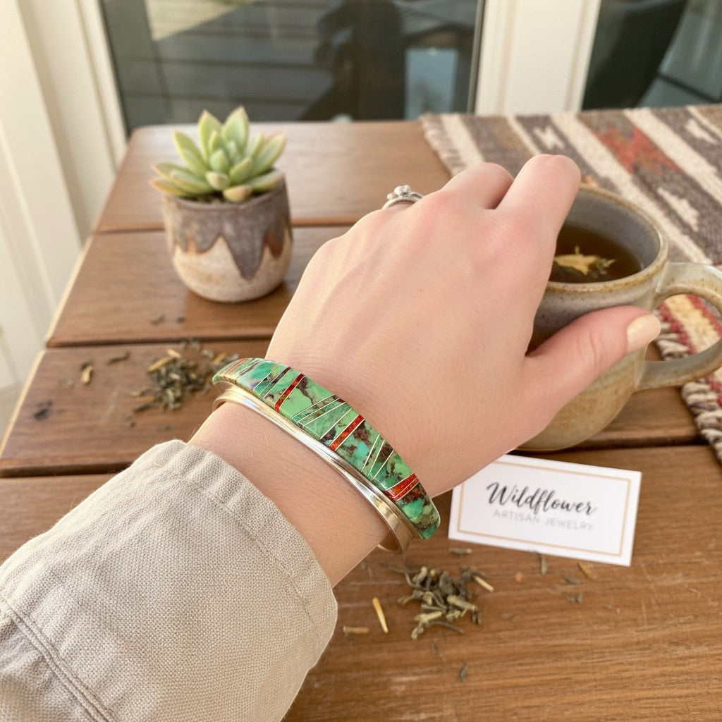 Wildflower Artisans sterling silver cuff with Sonoran Mountain turquoise and red opal channel inlay on a wrist.