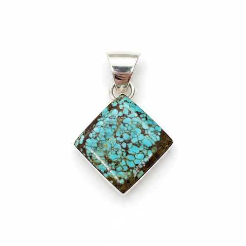 Wildflower Artisans square Number 8 spiderweb turquoise pendant set in sterling silver on a white background.