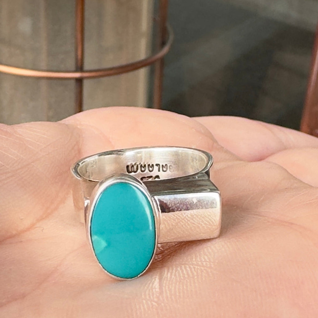 Wildflower Artisans BALAAM sterling silver ring with an oval teal turquoise cabochon on a wide flat architectural band
