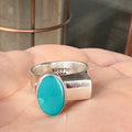 Wildflower Artisans BALAAM sterling silver ring with an oval teal turquoise cabochon on a wide flat architectural band