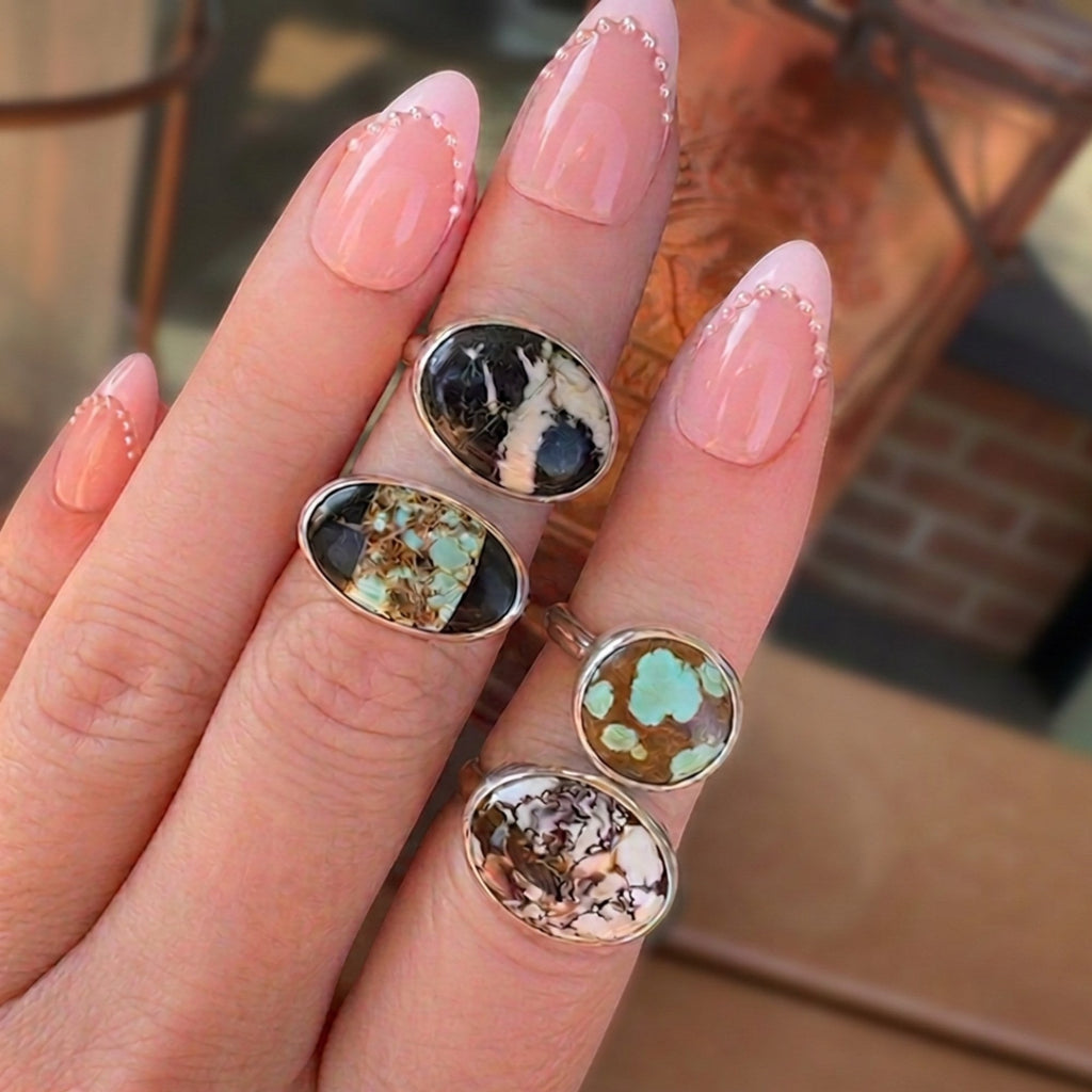 Wildflower Artisans sterling silver rings featuring various natural turquoise stones with unique matrix patterns