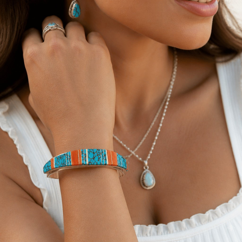 Wildflower Artisans sterling silver cuff with hand-inlaid turquoise and spiny oyster on a woman's wrist