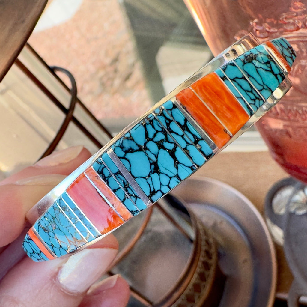 Wildflower Artisans sterling silver cuff bangle featuring hand-inlaid turquoise with black matrix and spiny oyster.