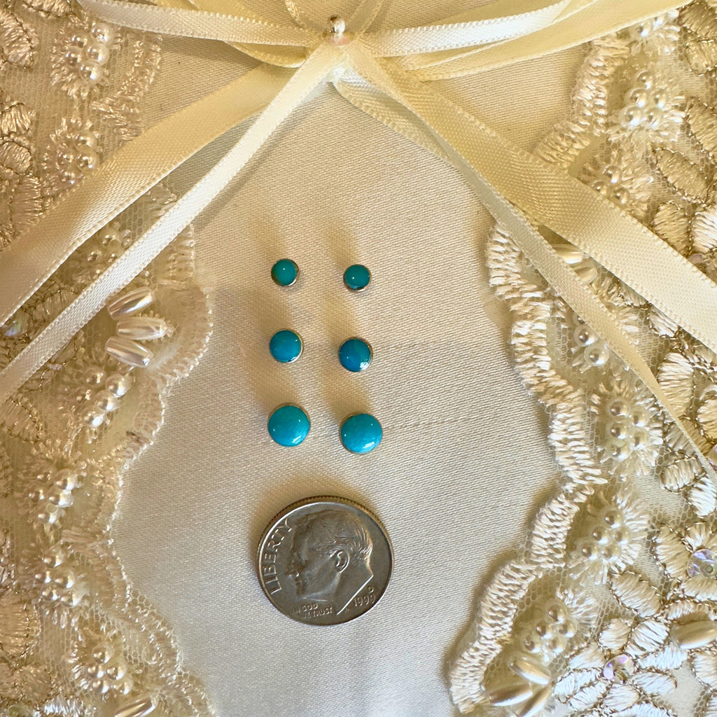 Wildflower Artisans turquoise stud earrings in sterling silver, shown in three sizes with a dime for scale.