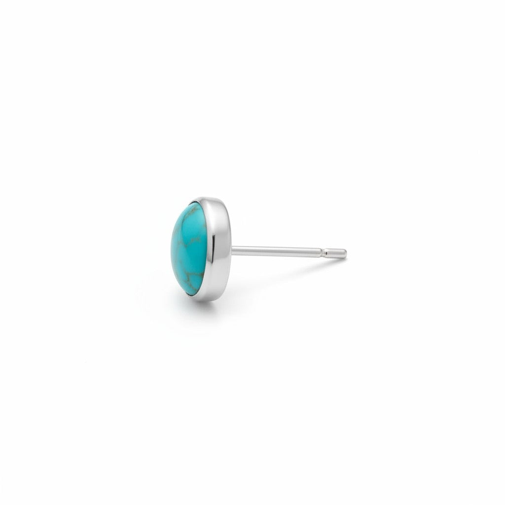 Wildflower Artisans turquoise stud earrings in sterling silver. Genuine turquoise cabochon with natural matrix, set in sterling silver.