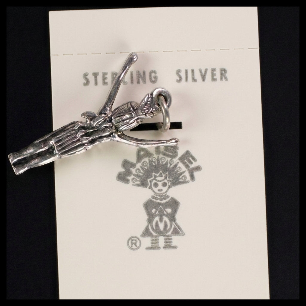 Wildflower Artisans vintage sterling silver figure charm with arms raised, attached to original Maisel's display card.