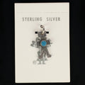 Wildflower Artisans vintage sterling silver figure charm with a turquoise cabochon on original Maisel's display card.