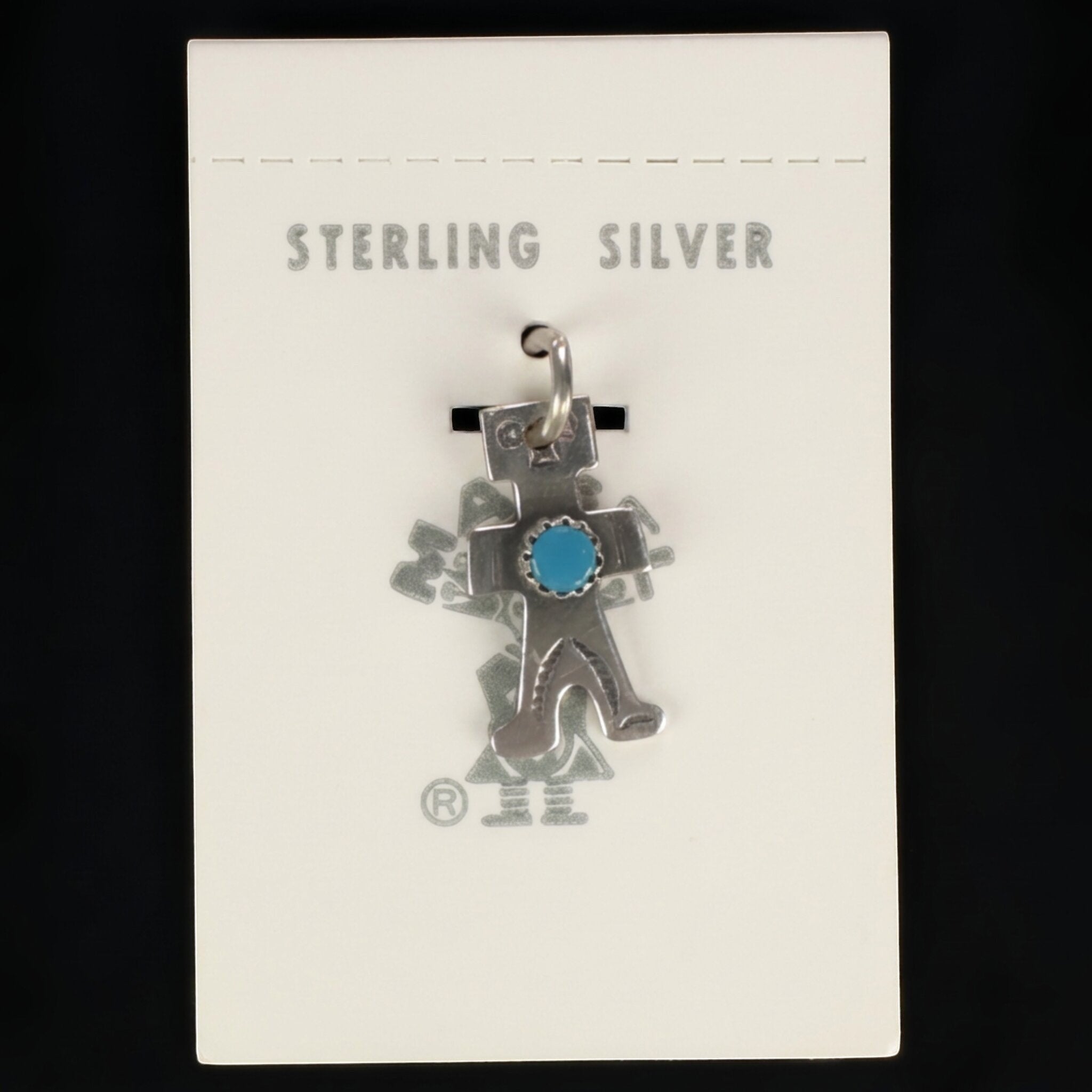 Wildflower Artisans vintage sterling silver figure charm with a turquoise cabochon on original Maisel's display card.