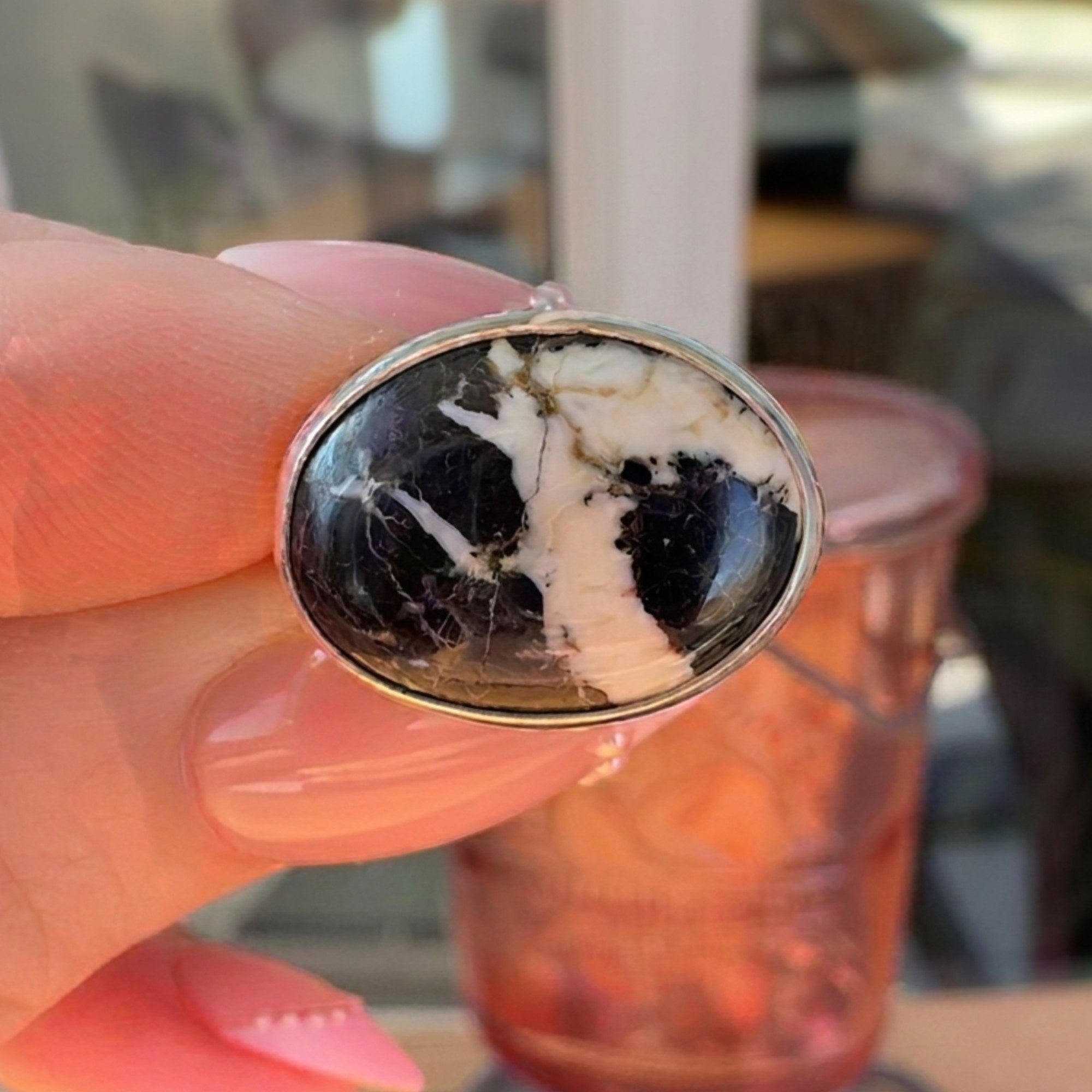 Wildflower Artisans sterling silver ring featuring a natural oval White Buffalo stone with charcoal veining.