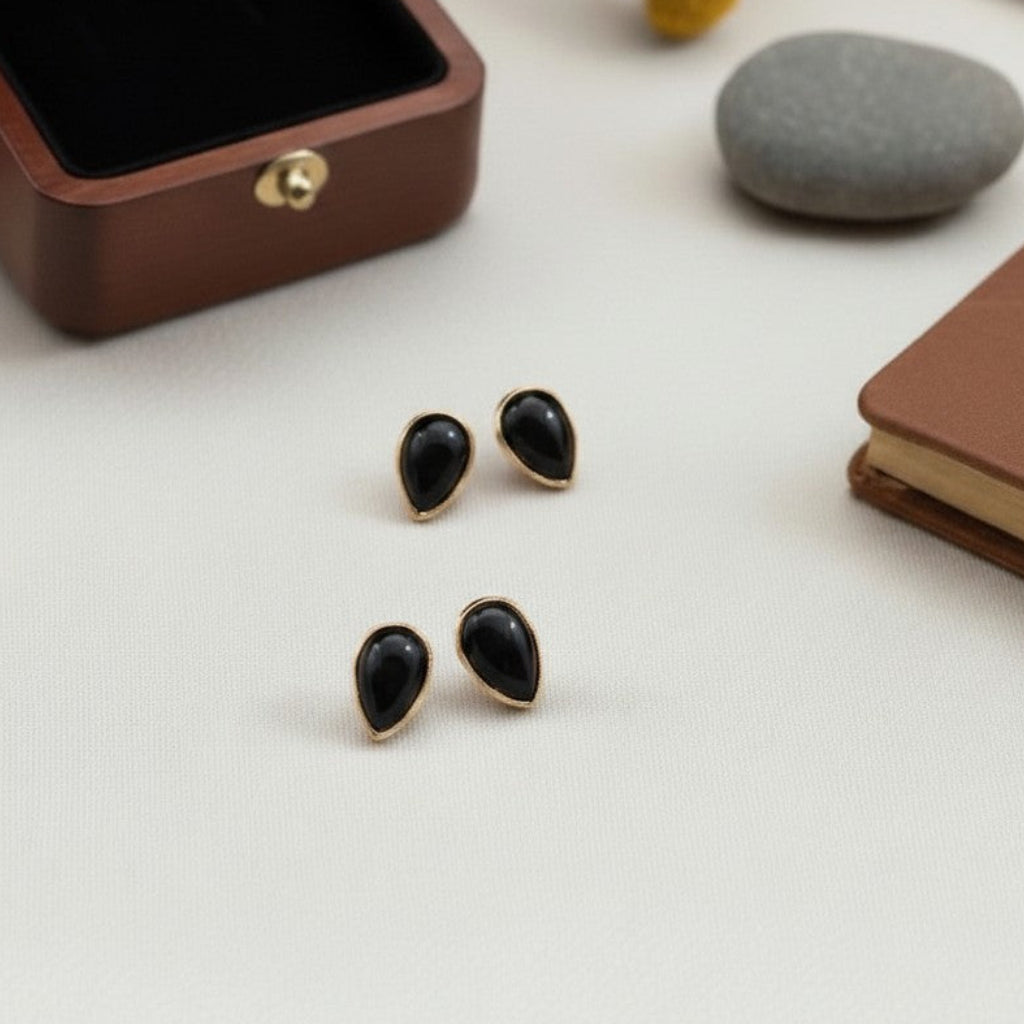 Wildflower black onyx teardrop stud earrings with 24K gold bezel, approximately 7x5mm.