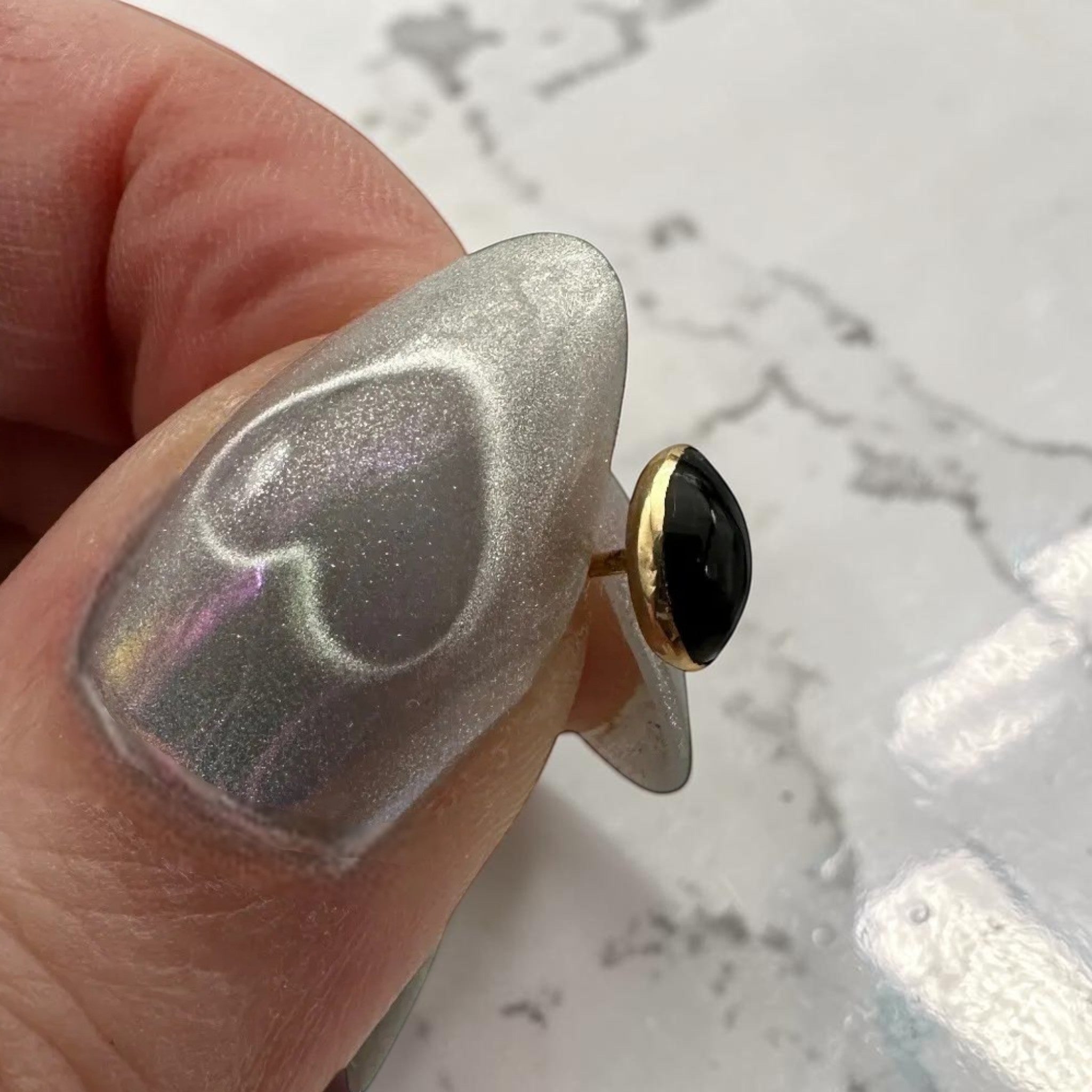 Wildflower black onyx teardrop stud earrings with 24K gold bezel. Pear-shaped polished onyx.