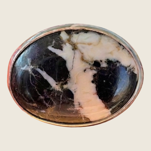 White buffalo stone ring in sterling silver, size 6.5, shown on a bone linen background